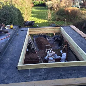 A picture of a house being built in the yard.