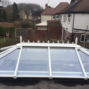 A white roof with a skylight on top of it.
