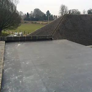 A man riding a skateboard on top of a cement ramp.