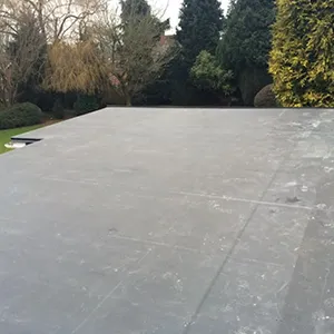 A man riding a skateboard on top of a cement slab.