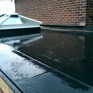 A flat roof with a skylight on top of it.
