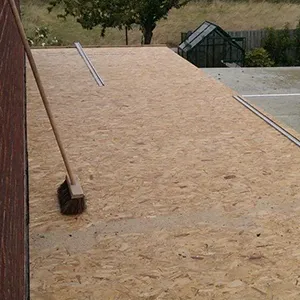 A tennis court with a broom leaning against the wall.