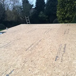 A flat roof with a ladder on top of it.
